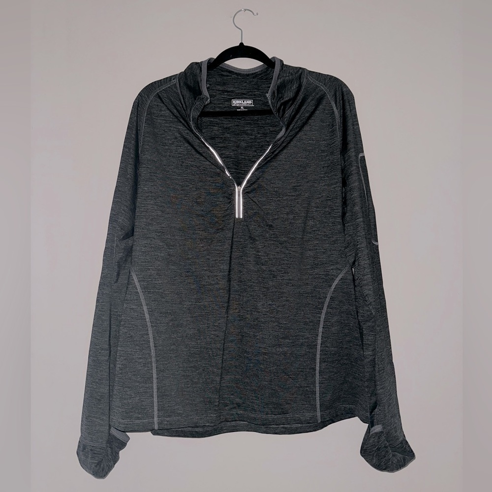 Heather grey long sleeve athletic top. Half zip front, thumb holes, arm pocket